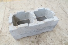 Concrete block made with crushed glass replacing c.25% of the sand and gravel.